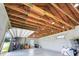 Spacious garage area with high ceilings and an open design concept, perfect for car storage and workshop activities at 10711 County Road 561, Clermont, FL 34711
