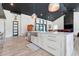 Open-concept kitchen featuring a large island, stainless steel appliances, and designer finishes at 10711 County Road 561, Clermont, FL 34711