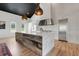 Modern kitchen featuring marble countertops, stainless steel appliances, and rustic wood island at 10711 County Road 561, Clermont, FL 34711
