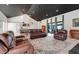 Open floor plan of living room and kitchen with plenty of furniture and a piano at 10711 County Road 561, Clermont, FL 34711