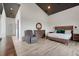 Tranquil main bedroom with a king-size bed, sitting area, and access to a private outdoor space at 10711 County Road 561, Clermont, FL 34711