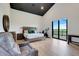 Spacious main bedroom includes a seating area, a king bed, and a sliding glass door to the patio at 10711 County Road 561, Clermont, FL 34711