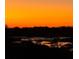Picturesque sunset view over the water and trees, perfect for relaxing evenings at 10711 County Road 561, Clermont, FL 34711