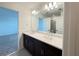 Stylish bathroom featuring double sinks, a large mirror, and dark wood cabinets at 1138 Calico Pointe Cir, Groveland, FL 34736