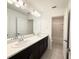 Bright bathroom featuring double sinks with quartz countertops and modern fixtures plus a shower/tub combo at 1138 Calico Pointe Cir, Groveland, FL 34736
