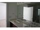 Bright bathroom featuring double sinks and spacious countertop at 1138 Calico Pointe Cir, Groveland, FL 34736