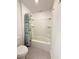 Bathroom with shower and tub featuring a shower rod and green and white floral shower curtain at 1138 Calico Pointe Cir, Groveland, FL 34736