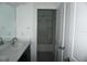Bathroom featuring a double sink vanity and a mirror, next to a shower at 1138 Calico Pointe Cir, Groveland, FL 34736