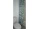 Bathroom with a toilet and a shower with patterned curtain at 1138 Calico Pointe Cir, Groveland, FL 34736