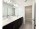 Modern bathroom featuring a double sink vanity with quartz countertop and dark wood cabinets at 1138 Calico Pointe Cir, Groveland, FL 34736