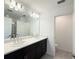 Modern bathroom featuring a double sink vanity with quartz countertop and dark wood cabinets at 1138 Calico Pointe Cir, Groveland, FL 34736