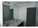 Bathroom featuring a double sink vanity and a mirror at 1138 Calico Pointe Cir, Groveland, FL 34736