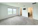 Bright bedroom with neutral carpet, two windows, bathroom and TV connection offering a peaceful retreat at 1138 Calico Pointe Cir, Groveland, FL 34736