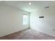Bedroom with neutral carpet, white walls, a window, recessed lighting, and ample space at 1138 Calico Pointe Cir, Groveland, FL 34736