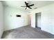 Bright bedroom featuring neutral carpet, a ceiling fan, closet, and pre-wired television mount at 1138 Calico Pointe Cir, Groveland, FL 34736