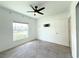 Sunlit bedroom featuring neutral carpet, a ceiling fan, and pre-wired television mount at 1138 Calico Pointe Cir, Groveland, FL 34736