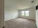 Spacious bedroom with neutral carpet and two windows, offering ample natural light and a comfortable living space at 1138 Calico Pointe Cir, Groveland, FL 34736