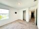 Bright, carpeted bedroom with a window, closet and wall mounted bracket at 1138 Calico Pointe Cir, Groveland, FL 34736