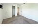 Spacious carpeted bedroom with closet and views to other rooms at 1138 Calico Pointe Cir, Groveland, FL 34736