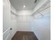 Walk-in closet with neutral carpet providing ample storage for clothes and accessories at 1138 Calico Pointe Cir, Groveland, FL 34736