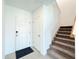 Bright entryway with tile flooring, a coat closet, and carpeted stairs at 1138 Calico Pointe Cir, Groveland, FL 34736