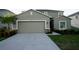 Two-story home featuring an attached two-car garage, neutral paint, and simple landscaping at 1138 Calico Pointe Cir, Groveland, FL 34736