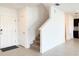 Bright entry featuring tile floors, coat closet, staircase to the second level, and access to the kitchen at 1138 Calico Pointe Cir, Groveland, FL 34736