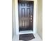 Inviting front door featuring a modern design and welcoming 'HOME' doormat at 1138 Calico Pointe Cir, Groveland, FL 34736