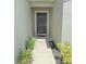 An eye-level shot of the front door with garden and solar lights along a small path at 1138 Calico Pointe Cir, Groveland, FL 34736