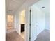 Upstairs hallway featuring carpet flooring and access to the laundry room and bathroom at 1138 Calico Pointe Cir, Groveland, FL 34736