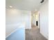 Upstairs hallway features neutral carpet and sight lines into multiple rooms at 1138 Calico Pointe Cir, Groveland, FL 34736