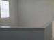 A bright hallway leads to the bedrooms upstairs with white trim and neutral walls at 1138 Calico Pointe Cir, Groveland, FL 34736