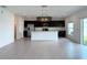 Modern kitchen featuring an island, stainless steel appliances, and dark cabinetry at 1138 Calico Pointe Cir, Groveland, FL 34736