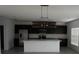 Open kitchen featuring stainless steel appliances, a kitchen island with bar stool seating, and modern lighting at 1138 Calico Pointe Cir, Groveland, FL 34736