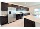 Modern kitchen with stainless steel appliances and dark cabinetry at 1138 Calico Pointe Cir, Groveland, FL 34736