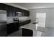 Modern kitchen featuring stainless steel appliances, a kitchen island, and ample cabinet space at 1138 Calico Pointe Cir, Groveland, FL 34736