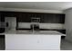 Bright kitchen featuring stainless steel appliances, a kitchen island, and ample cabinet space at 1138 Calico Pointe Cir, Groveland, FL 34736