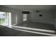 Spacious living room featuring neutral tiling, white walls, modern lighting, and a ceiling fan at 1138 Calico Pointe Cir, Groveland, FL 34736