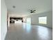 Open-concept living room featuring ceramic tile flooring, fan, and natural lighting with sliding door access to outdoor area at 1138 Calico Pointe Cir, Groveland, FL 34736
