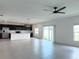 Spacious open-concept living room flows into the kitchen with stainless appliances and white island at 1138 Calico Pointe Cir, Groveland, FL 34736