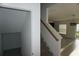 Bright stairway featuring carpeted steps, white risers, and a wooden handrail leading to the upper level at 1138 Calico Pointe Cir, Groveland, FL 34736