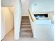 Carpeted staircase leading to the second floor with a view of the open-concept kitchen and living area at 1138 Calico Pointe Cir, Groveland, FL 34736