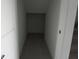 Under-stairs storage area with tiled floors; can be used as a closet or pantry for extra household supplies at 1138 Calico Pointe Cir, Groveland, FL 34736