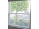 Window with horizontal blinds offering natural light and street view at 1138 Calico Pointe Cir, Groveland, FL 34736