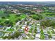 Aerial view of home with surrounding community golf course, clubhouse, and roadways at 1142 W Boone Ct, Lady Lake, FL 32159