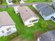 Aerial view of home with neutral roof, well-kept lawn, and mature landscaping at 1142 W Boone Ct, Lady Lake, FL 32159