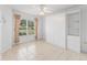 Bedroom featuring neutral paint, tile flooring and large window at 1142 W Boone Ct, Lady Lake, FL 32159