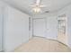 Bedroom featuring neutral paint, tile flooring and built in closet system at 1142 W Boone Ct, Lady Lake, FL 32159