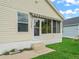 Home exterior featuring neutral siding, awning, concrete steps, and well-kept lawn at 1142 W Boone Ct, Lady Lake, FL 32159