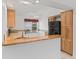 The kitchen features granite countertops, wood cabinets, and black appliances at 1142 W Boone Ct, Lady Lake, FL 32159